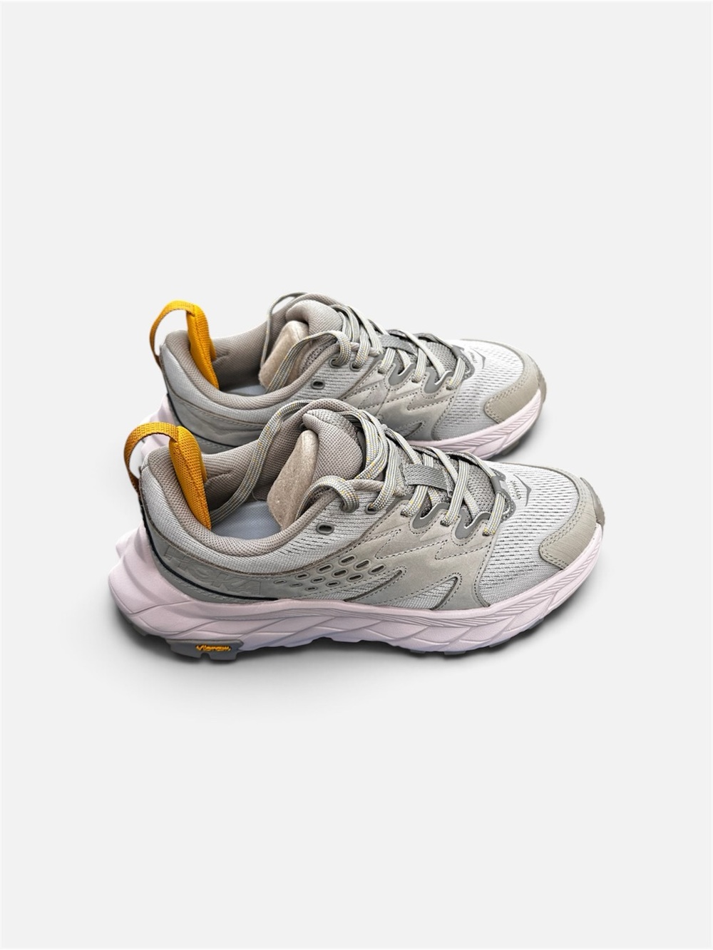 Hoka Women's Light Gray Sneakers with Pink Sole and Yellow Pull Tab